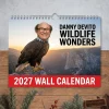 Hanging wall calendar featuring a bald eagle with a human head against a mountain landscape background.