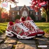 Side view of Delta Sigma Theta Elephant Air Max Plus Sneaker on cobblestone with red and white details.