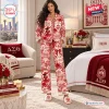 Front view of a woman wearing a red and white patterned Delta Sigma Theta Satin Pajama Set in a bedroom setting.