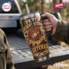 Hand holding a Desert Storm Marine Corps YETI Tumbler Cup outdoors.