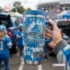 Hand holding a blue tie-dye Detroit Lions 96th Anniversary Tumbler with Handle at a stadium tailgate.