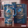 Front view of Detroit Lions 96th Anniversary Tumbler with Handle next to matching box on wooden table.