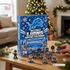 Front view of a blue Detroit Lions advent calendar surrounded by small player figurines on a wooden table.