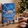 Front view of a blue Detroit Lions Advent Calendar box with miniature figurines on a wooden table.