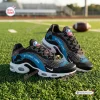 Side view of Detroit Lions Black Air Max Plus Sport Shoes resting on green turf.