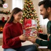 A man and woman holding a red Diet Coke & Coca-Cola All Flavors Advent Calendar 2026 box by a Christmas tree.