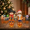 Dragon Ball 40th Anniversary Advent Calendar 2026 solid 3D vinyl figures of Kid Goku and Santa Roshi on glowing amber dragon ball pedestals