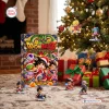 Front view of a Dragon Ball Z Advent Calendar Blind Box placed near a decorated Christmas tree with wrapped gifts.
