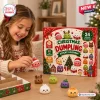 A smiling child holding a small red dumpling toy next to a Christmas Dumpling Squishy Toy Advent Calendar box on a table.