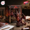 Front view of Dungeons and Dragons Red Dragon figurine standing on a twenty sided die next to its packaging box.
