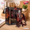 Front view of the Dungeons and Dragons Red Dragon 52nd Anniversary Figurine posed next to its box and a large twenty-sided die.