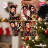 Close-up of a decorative LOVE Christmas ornament featuring singer portraits, records, and musical motifs.