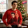 Front view of a man wearing a red Elvis Presley Ugly Christmas Sweater featuring a portrait and Christmas tree graphic.