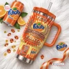 Top-down view of Fanta 86th Anniversary YETI Handle Tumbler surrounded by orange slices, crystals, and a soda can.