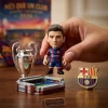 Close-up view of hand holding a miniature figurine with trophy and stadium model from FC Barcelona 2026 Advent Calendar.