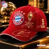 Front view of an FC Bayern Munich Red Harry Kane Signed Baseball Cap featuring gold signature and crest on a dark surface.
