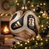 Close-up of a FIFA World Cup 2026 Final Match Gold Edition Trionda Ball Christmas Ornament hanging on a lit tree.