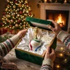 Hands opening a green velvet box containing a FIFA World Cup 2026 Golden Trophy & Trionda Ball Christmas Ornament.