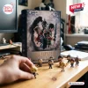 Angle view of Final Fantasy VII 30th Anniversary Advent Calendar box with small figurines on wooden table.