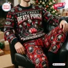 Front view of a person wearing a Five Finger Death Punch Christmas sweater and plaid jogger set seated on a leather chair.