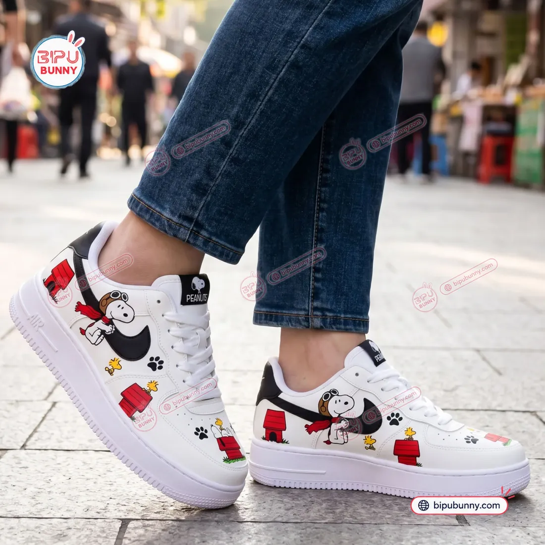 Flying Ace Snoopy Low-Top Air Force Sneakers worn on city pavement with cuffed denim jeans