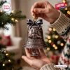 Close-up of a bronze Forbidden Planet Robby The Robot 70th Anniversary Bell Ornament held in hands.