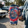 Close-up of a tie-dye Ford Mustang 62nd Anniversary Handle Tumbler held outdoors.