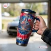 Hand holding a Ford Mustang 62nd Anniversary Handle Tumbler with tie-dye pattern and car graphics.