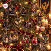 Closeup of Fourth Wing The Empyrean 2026 Advent Calendar ornaments hanging on a lit Christmas tree.