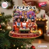 Close-up of a Friends 1994 Resin Christmas Ornament featuring six characters on an orange sofa.