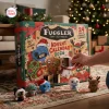 Close-up of hands opening a Fuggler Funny Ugly Monster Advent Calendar 2026 box with small plush monsters nearby.