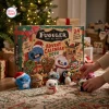 Front view of the Fuggler Funny Ugly Monster Advent Calendar 2026 box with plush toys displayed on the floor.