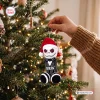 Close-up of a crocheted holiday ornament hanging on a lit Christmas tree.