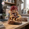 Front view of Gaara Naruto Shippuden Hidden Sand vinyl figure on a desk with sand effects.