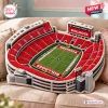 Angled view of the Georgia Bulldogs Sanford Stadium plush pillow resting on a beige sofa.