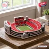 High angle view of a Georgia Bulldogs Sanford Stadium plush pillow shaped like a football arena on a wooden table.