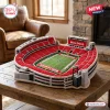 Angled view of a Georgia Bulldogs Sanford Stadium plush pillow resting on a wooden table.