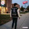 Back view of a person wearing the Ghostface Woodsboro Scary Movie Varsity Jacket outdoors at dusk.
