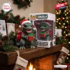 Front view of Godzilla 2026 Christmas Vinyl Figure wearing a Santa hat and holding a gift on a mantle.