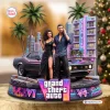 Front view of a Grand Theft Auto VI Collectible Figure featuring two characters, a classic car, palm trees, and an Ocean View hotel backdrop.