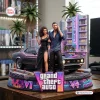 Front view of a Grand Theft Auto VI collectible figure featuring two characters, a muscle car, and a neon hotel backdrop.
