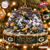 Front view of a Green Bay Packers Ice Bowl Christmas Ornament featuring a sculpted football player pileup on snow.