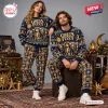 Front view of two models wearing the Greta Van Fleet Christmas Sweater And Jogger Pants Set in a holiday setting.