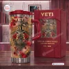 Front view of Guns N Roses Limited Edition Tumbler with red roses and crossed pistols next to its box.