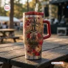 Front view of Guns N Roses Limited Edition Tumbler featuring a red handle, straw, and rose graphic on a wooden table.