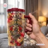 Hand holding a Guns N Roses tumbler with red roses and crossed pistols graphic.