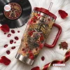Top-down view of a red-handled Guns N Roses tumbler with rose and revolver graphics on white fur.