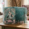 Open teal advent calendar with numbered doors and acrylic character figures on a wooden table.