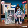 Hatsune Miku 20th Anniversary Limited Edition Figure next to its packaging box on a wooden shelf.