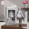 Front view of a silver haired collectible figure wearing an ornate white and grey dress standing next to its box.